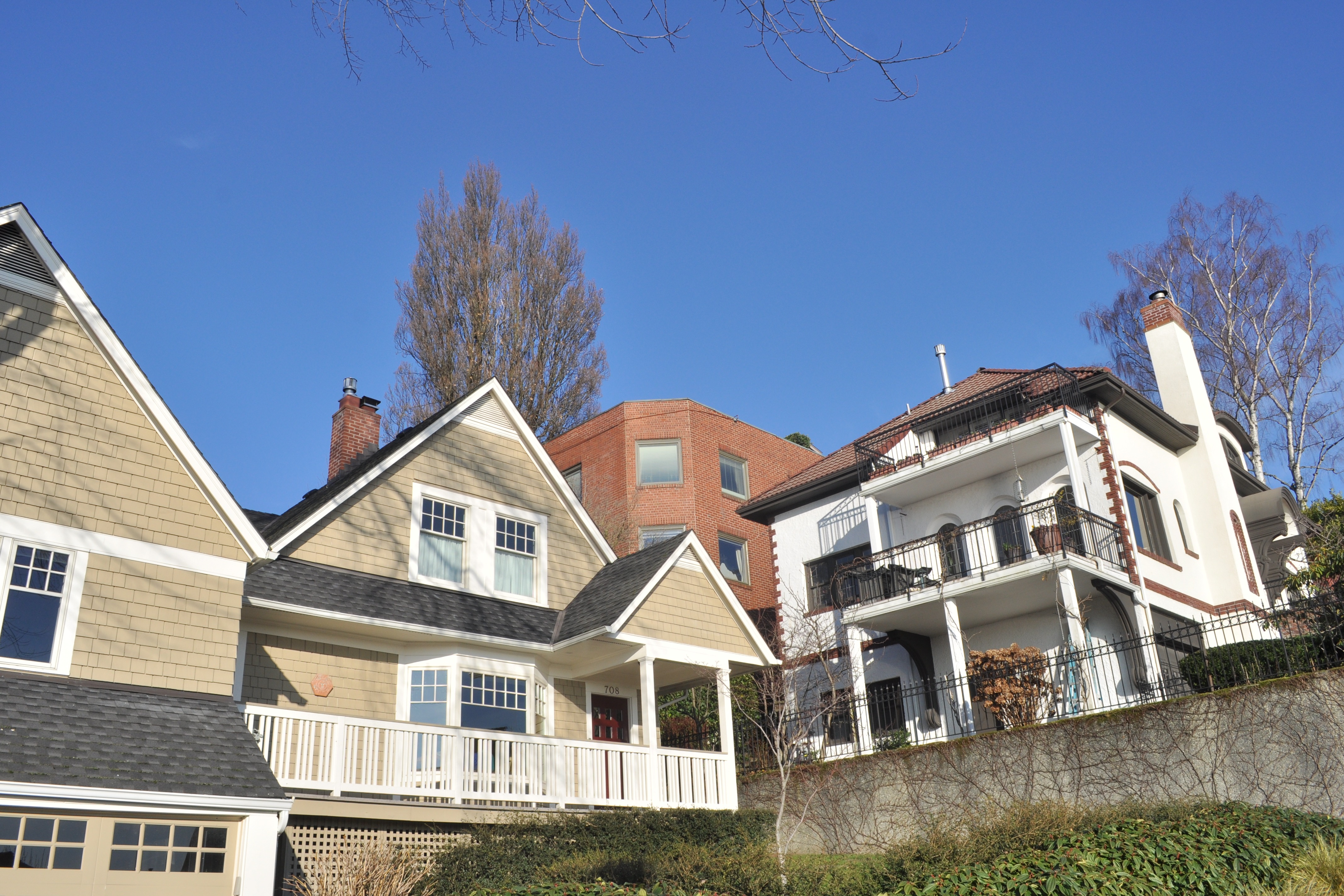 Houses on the southwest side of Queen Anne Hill in Seattle, along the 700 block of West Prospect Street, with mature street trees